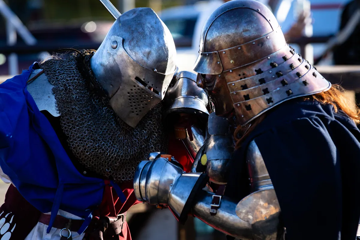 Two fighters in steel helms locked together